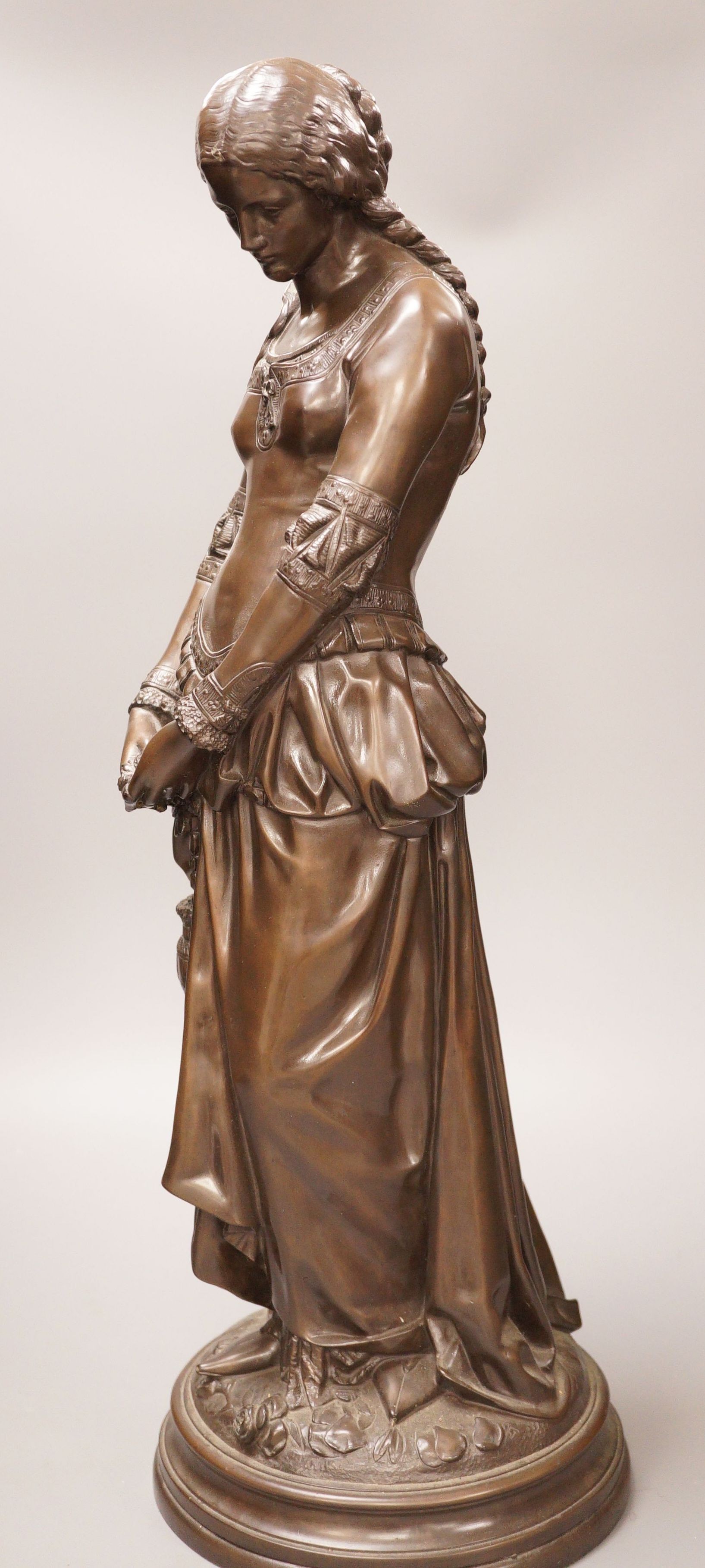 After Boisseau, a tall bronzed metal figure of a standing maiden, signed to verso, 58cm tall